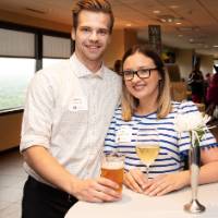 2 people standing at table